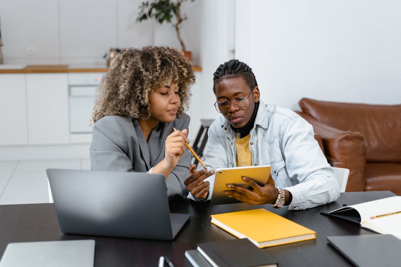 A Man and Woman Planning while Looking at the Tablet